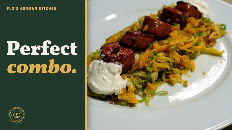 Pumpkin Spätzle stir fry with Savoy cabbage and Käsekrainer, served with sour cream